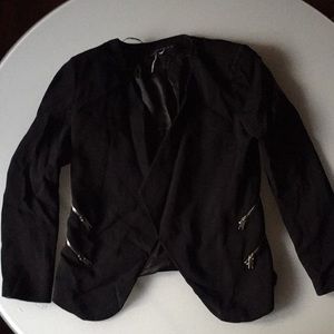 Black blazer with double zipper on each side.